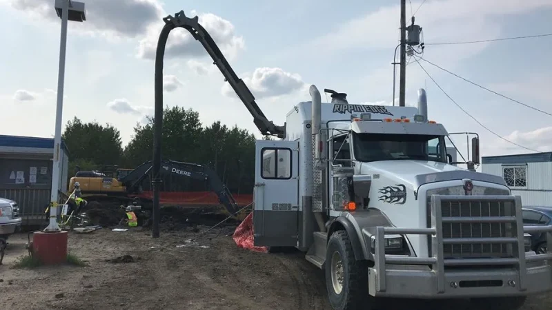 White Rippin Edge hydrovac truck works on commercial property