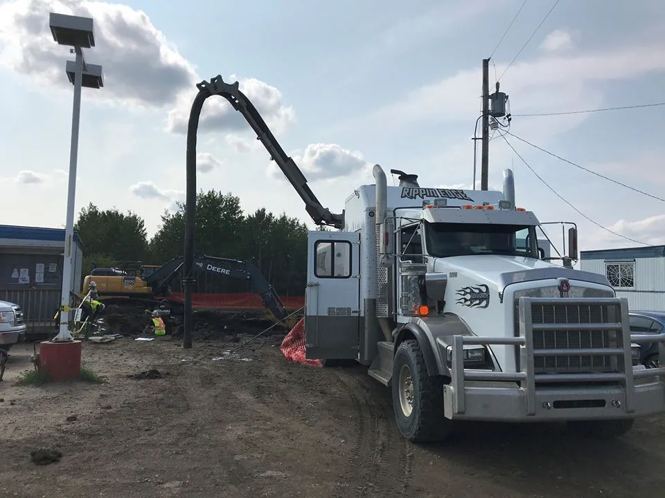 White Rippin Edge hydrovac truck works on commercial property