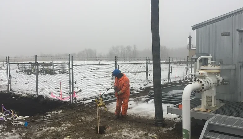 Hydrovac worker working in the snow