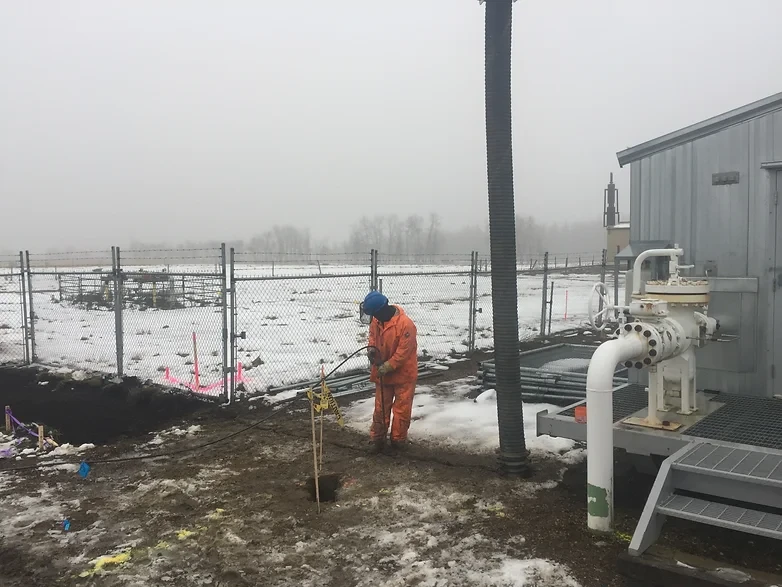 Hydrovac worker working in the snow