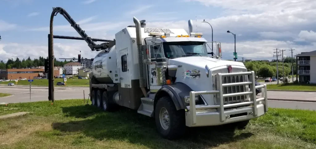 White Rippin Edge hydrovac truck parked in mid-day on roadside