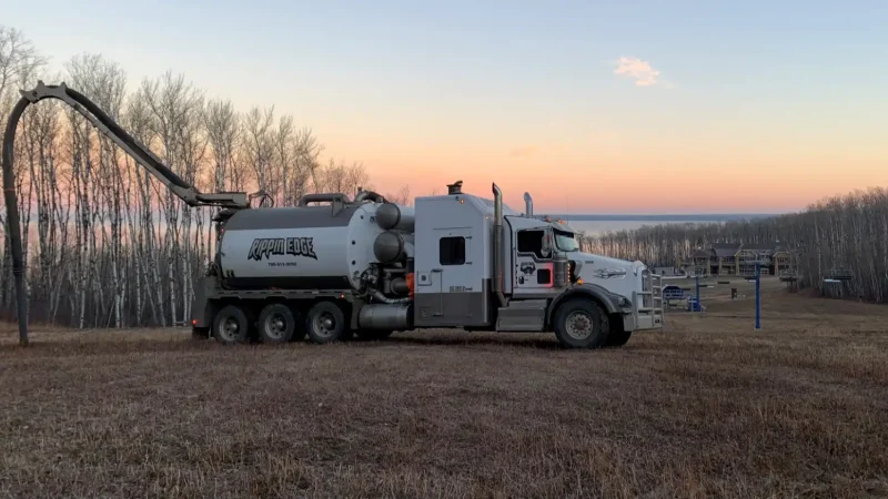 Rippin Edge hydrovac truck in park at sunset